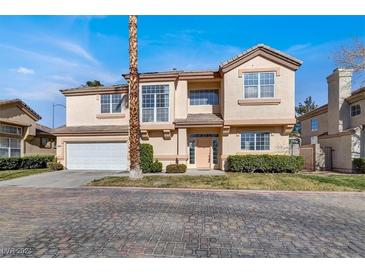 Two-story house with attached garage and landscaped front yard at 8010 Arcadian Ln, Las Vegas, NV 89147