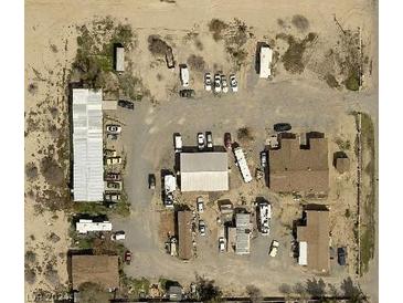 Expansive aerial view of a commercial lot featuring multiple buildings and ample parking space at 1130 N Leslie St, Pahrump, NV 89060