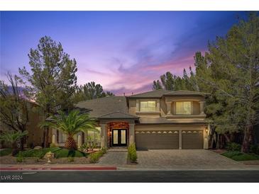 Charming two-story home with a three-car garage, desert landscaping, and a beautiful brick entryway at 4156 Balmoral Castle Ct, Las Vegas, NV 89141