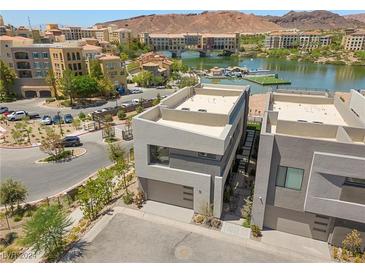 Contemporary home showcasing minimalist design with views of the serene lake and surrounding community at 14 Heron Harbour Dr, Henderson, NV 89011