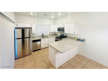 Modern kitchen with stainless steel appliances and granite countertops at 3205 Mystic Ridge Ct, Las Vegas, NV 89129