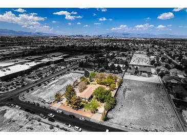 Aerial view of house, large yard, and surrounding city views at 1860 E Ford Ave, Las Vegas, NV 89123