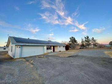 Single story home with solar panels and large yard at 1310 Fremont St, Pahrump, NV 89048