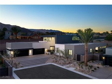 Modern two-story home with attached garage and desert landscaping at 4377 Cameron Brook Ct, Las Vegas, NV 89129