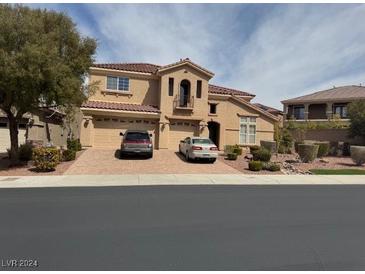 Charming two-story home with a red tile roof, multiple-car garage, and well-manicured front yard at 2742 Kingclaven Dr, Henderson, NV 89044