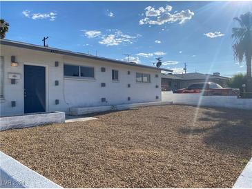 Ranch style home with a gravel front yard and blue front door at 4313 El Conlon Ave, Las Vegas, NV 89102