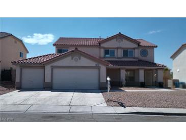 Two-story house with attached two-car garage and red tile roof at 6449 Elizabethtown Ave, Las Vegas, NV 89110