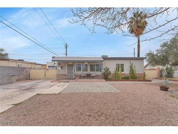 Charming single-story home featuring a landscaped front yard and cozy porch area at 1334 Eastwood Dr, Las Vegas, NV 89104