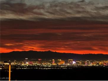 Stunning nighttime aerial view showcasing city lights and mountain backdrop at 270 Besame Ct, Las Vegas, NV 89138