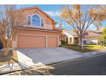 Two-story house with three-car garage, landscaping, and a large front yard at 2257 Loring Ave, Henderson, NV 89074