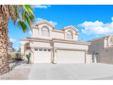 Charming two-story home features a three car garage, tile roof, and easy to maintain landscaping at 2196 Pescara Ct, Las Vegas, NV 89123