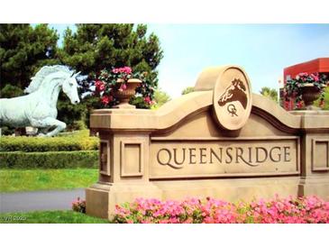 Queensridge entrance with horse sculpture and colorful flower beds at 9809 Miss Peach Ave, Las Vegas, NV 89145