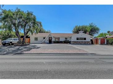 Charming single-story home with mature tree, brick accents and a long driveway at 2213 W Oakey Blvd, Las Vegas, NV 89102