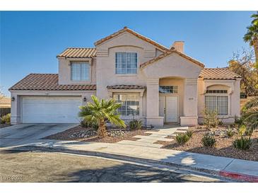 Two-story house with a landscaped front yard and attached garage at 8209 Crows Nest Ln, Las Vegas, NV 89128