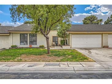 Charming single-story home with a well-maintained lawn, mature landscaping, and an attached two-car garage at 5701 Pearldrop Ave, Las Vegas, NV 89107