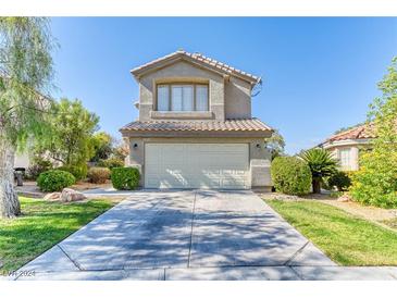 Two-story house with attached garage and landscaped front yard at 2345 Silver Crew Pass, Henderson, NV 89052