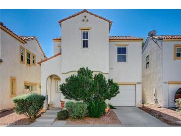 Charming two-story stucco home features a well-manicured front yard, arched entry, and attached garage at 6271 Sunset Spring Ave, Las Vegas, NV 89122