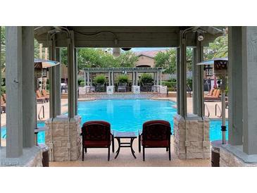 Beautiful community pool featuring seating with a relaxing view of the water at 8721 Red Brook Dr # 203, Las Vegas, NV 89128