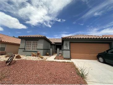 Charming single-story home with desert landscaping and a two-car garage, displaying a cozy and inviting curb appeal at 5025 Vista Loma Way, North Las Vegas, NV 89031