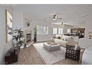 Virtually staged living room featuring a fireplace and open floor plan at 5727 Golden Leaf Ave, Las Vegas, NV 89122