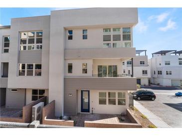 Modern three-story townhome with a two-car garage and private balcony at 655 Spotted Falcon St, Las Vegas, NV 89138