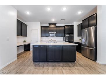 Modern kitchen with island, stainless steel appliances, and dark cabinetry at 2555 Hampton Rd # 4308, Henderson, NV 89052