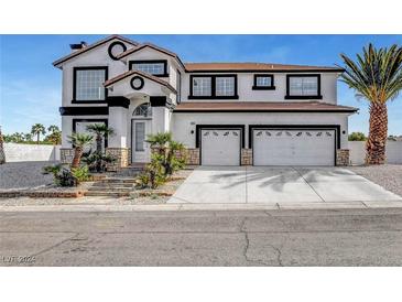 Two-story stucco home with a two car garage, palm trees and stone accents at 6315 N El Capitan Way, Las Vegas, NV 89149
