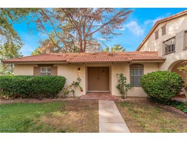 Charming single-story home with a red tile roof, a well-maintained lawn, and mature landscaping at 3125 Pinehurst Dr # A, Las Vegas, NV 89109