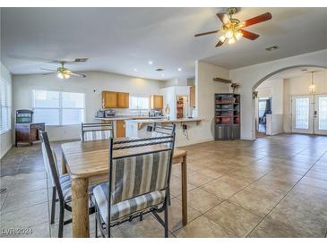 Bright dining area with tile floors and wood table at 6209 Peggotty Ave, Las Vegas, NV 89130