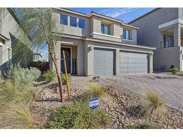 Two-story home features a two-car garage and low-maintenance desert landscaping at 10172 Magnolia Creek St, Las Vegas, NV 89141