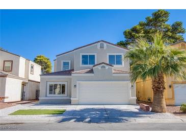 Two-story house with a white garage door and palm tree landscaping at 2032 Jesse Scott St, Las Vegas, NV 89106