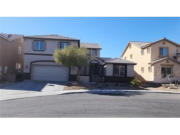 Charming two-story home featuring a well-manicured front yard and a two-car garage at 6231 Sun Seed Ct, North Las Vegas, NV 89081