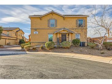 Two-story home with desert landscaping, shuttered windows, and a welcoming covered porch at 1065 Admiral Emblem St, Henderson, NV 89015