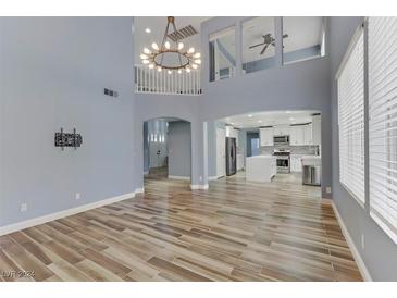 Open living room with high ceilings and hardwood floors at 8774 Libertyvale Dr, Las Vegas, NV 89123