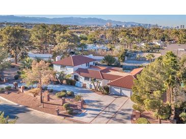 Stunning home with red tile roof, lush landscaping, and city views in a desirable neighborhood at 2868 Vista Del Sol Ave, Las Vegas, NV 89120