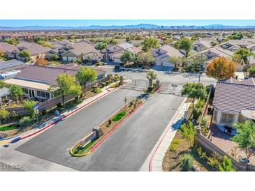 Aerial view of community entrance and homes with mountain views at 5912 Sea Hunter St, North Las Vegas, NV 89031