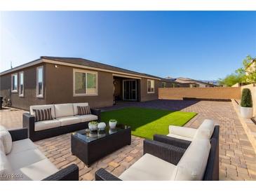 Spacious backyard with patio furniture and grassy area at 6204 Gambetta St, Las Vegas, NV 89115