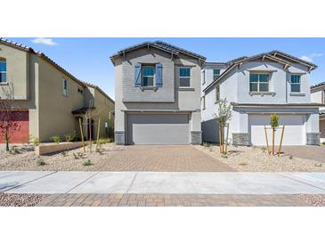 Charming two-story home with a brick driveway and attached two-car garage at 651 N Water St, Henderson, NV 89015