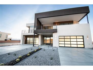 Contemporary two-story home with contrasting black and white exterior, two-car garage and desert landscaping at 3690 S Spring Mountain Blvd, Pahrump, NV 89048