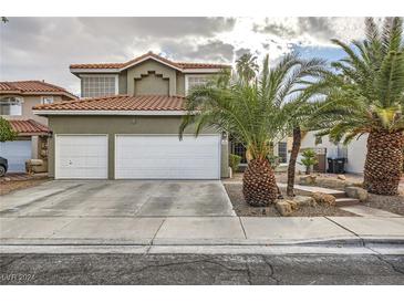 Two-story house with a three-car garage and landscaped yard at 259 Sandrock Pointe Ln, Henderson, NV 89012