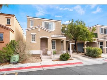 Charming two-story home featuring a stucco facade, well-maintained landscaping, and covered entry at 10332 Perfect Parsley St, Las Vegas, NV 89183