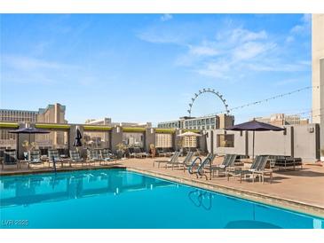 Rooftop pool featuring comfortable lounge chairs and views of the Las Vegas skyline, including the High Roller observation wheel at 211 E Flamingo Rd # 610, Las Vegas, NV 89169