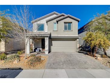 Two-story house with gray siding, gray garage door, and landscaped front yard at 3164 Rowan Brook Ave, Henderson, NV 89052