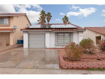 House exterior features solar panels and a landscaped yard at 6724 Reggie Cir, Las Vegas, NV 89107