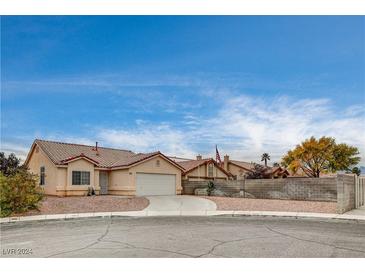 Charming single-story home featuring a well-maintained yard with desert landscaping and circular driveway at 5217 Yellow Dawn Ct, Las Vegas, NV 89130