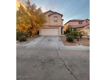 Two-story house with attached garage and landscaping at 11177 Deluna St, Las Vegas, NV 89141