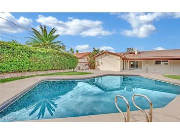 Inviting swimming pool with spacious patio area, perfect for relaxation and entertaining at 1501 Strong Dr, Las Vegas, NV 89102