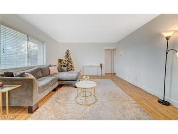 Inviting living room with a large sectional sofa, soft carpet, and plenty of natural light at 1420 Vegas Valley Dr # 18, Las Vegas, NV 89169