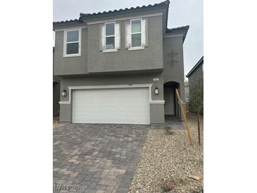 Two-story home featuring a two-car garage and neutral gray paint and nice stone-look driveway at 4202 Yucca Brevi Ave, Las Vegas, NV 89139