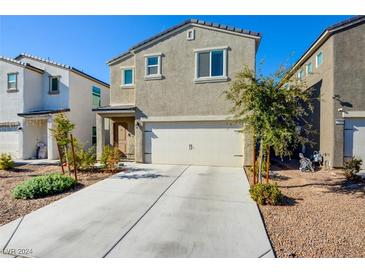 Two-story house with attached garage and landscaped front yard at 5029 Bloodhound St, Las Vegas, NV 89122